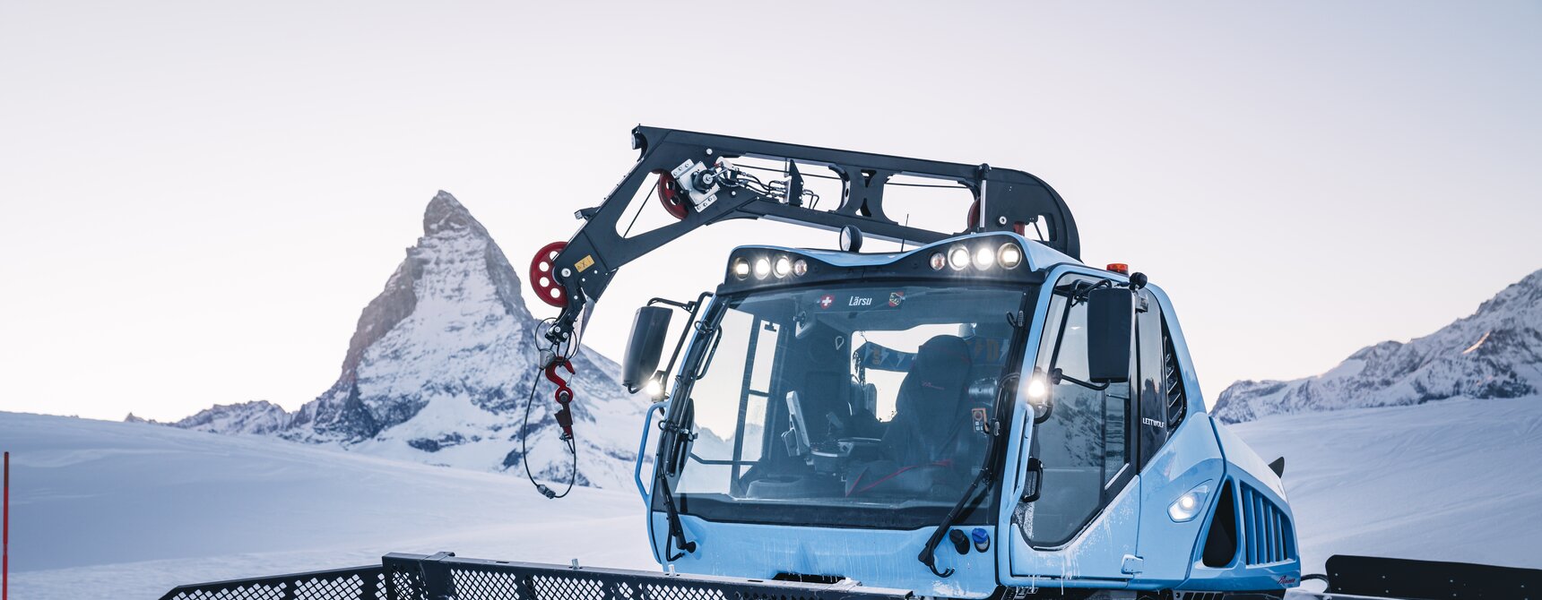 Snow groomer with winch at dawn | © Gabriel_Perren